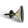 Espresso tamper with a wide flat bottom and ridged edge, used to compress coffee grounds in a portafilter, resting on its side on a white background